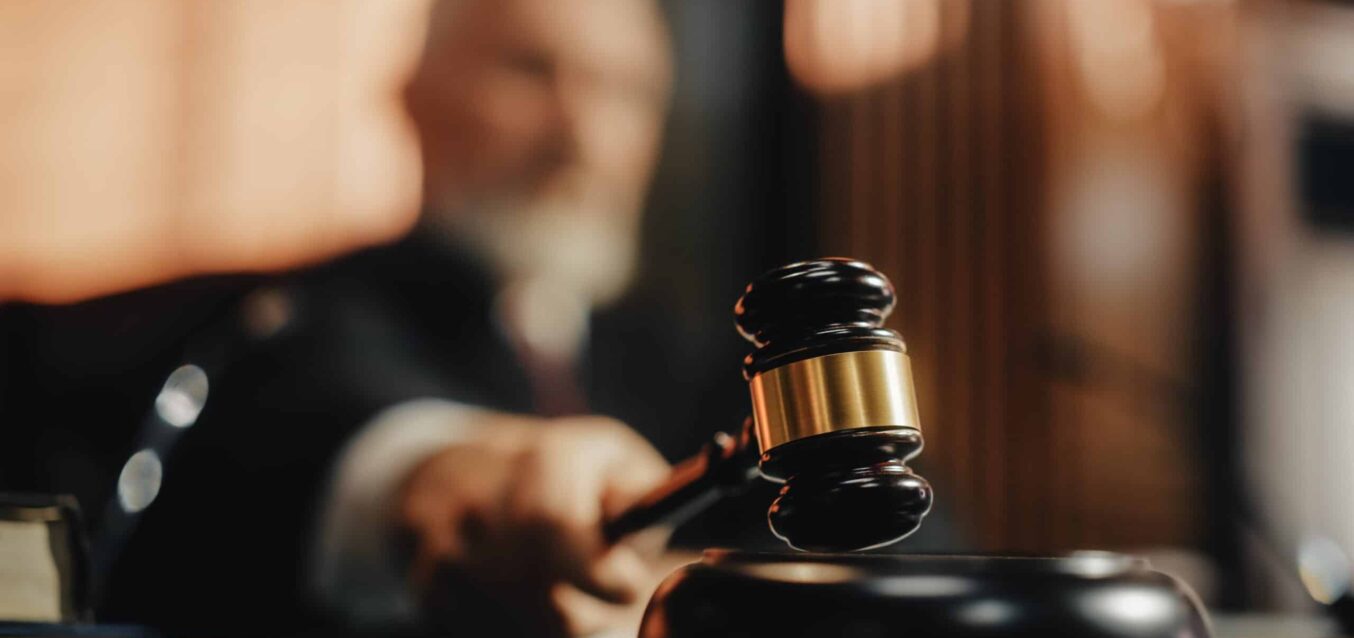 Court of Law and Justice Trial Session: Imparcial Honorable Judge Pronouncing Sentence, striking Gavel. Focus on Mallet, Hammer. Cinematic Shot of Dramatic Not Guilty Verdict. Close-up Shot.