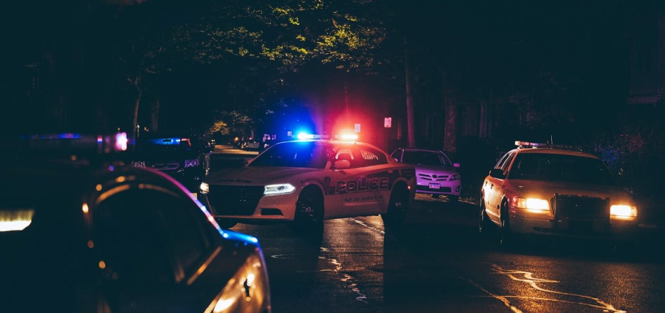 A couple of police cars parked in a parking lot